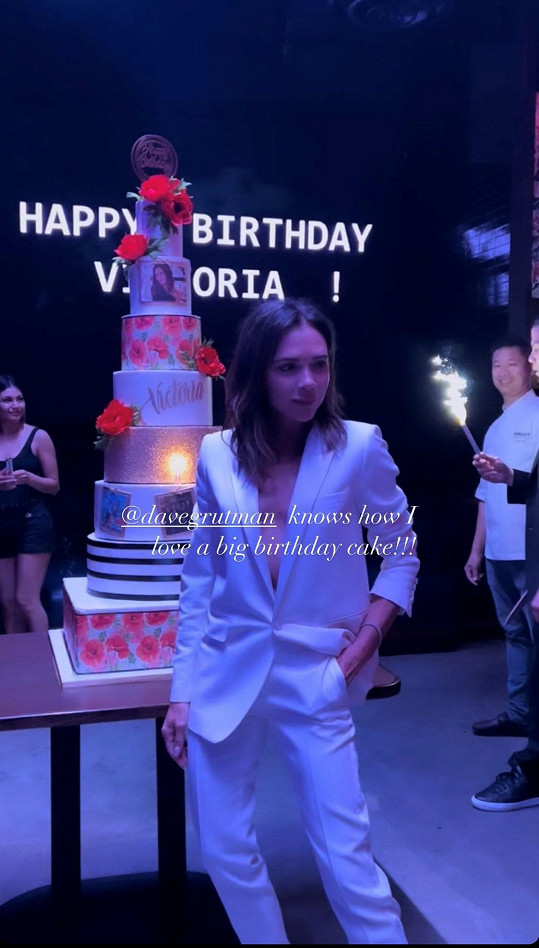 Victoria Beckham v kostýmku vlastní značky s obřím dortem, který dostala ke 48. narozeninám. 